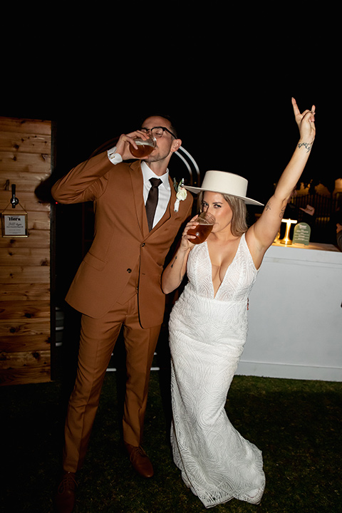  a groovy barn wedding with a neutral color palette and beer - couple pouring beer 