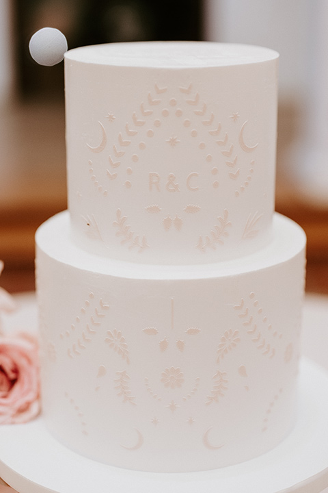  boho beach wedding with Spanish inspired architecture with the bride in a lace gown and the groom in a black tuxedo – cake 