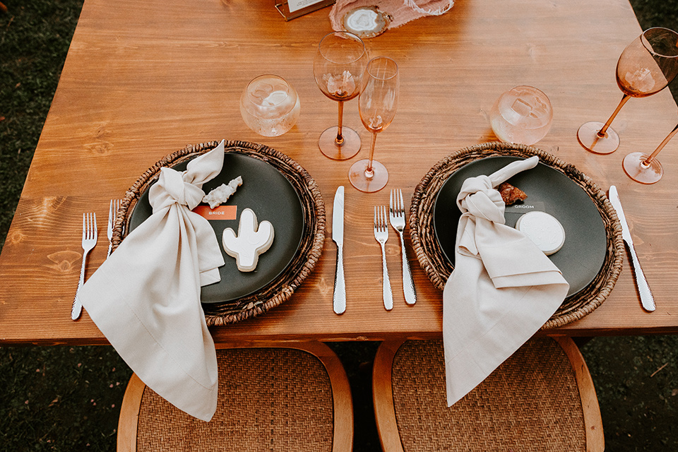  boho beach wedding with Spanish inspired architecture with the bride in a lace gown and the groom in a black tuxedo – table decor