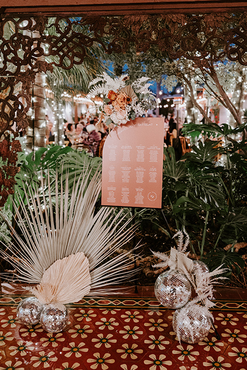  boho beach wedding with Spanish inspired architecture with the bride in a lace gown and the groom in a black tuxedo –signage 