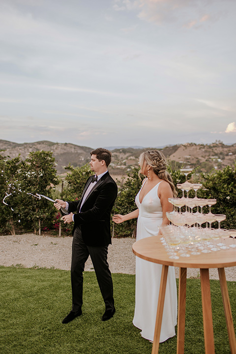  pink and black ranch wedding with elegant details - couple and champagne tower 