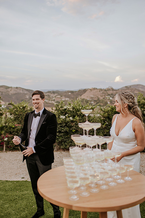  pink and black ranch wedding with elegant details - couple and champagne tower 