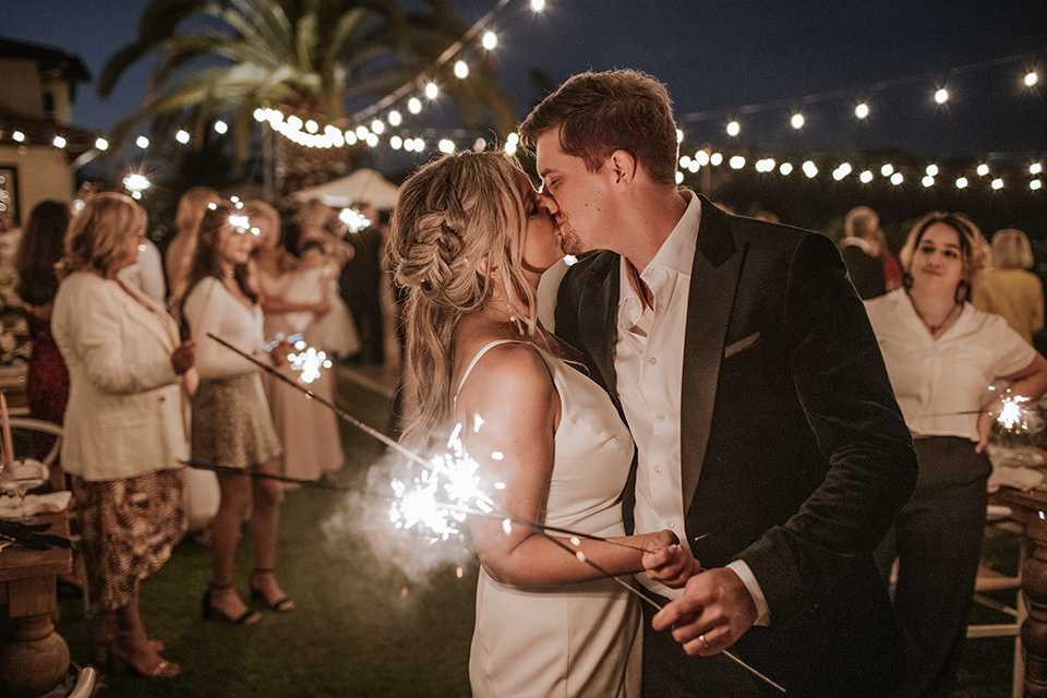  pink and black ranch wedding with elegant details - kissing with sparklers 