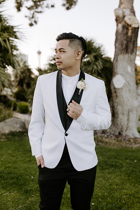  christine and gabes stunning black and white wedding with tropical touches – groom in a white and black tuxedo look 