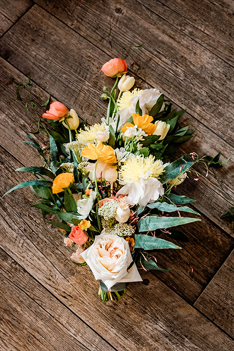  whimsical wedding at an ocean front venue with the groom in a mix and match look with navy and grey colors – boutonnière