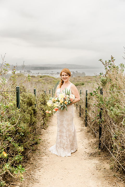  whimsical wedding at an ocean front venue with the groom in a mix and match look with navy and grey colors – bride 