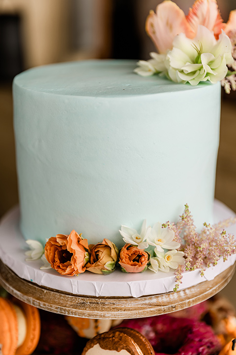  whimsical wedding at an ocean front venue with the groom in a mix and match look with navy and grey colors – cake 
