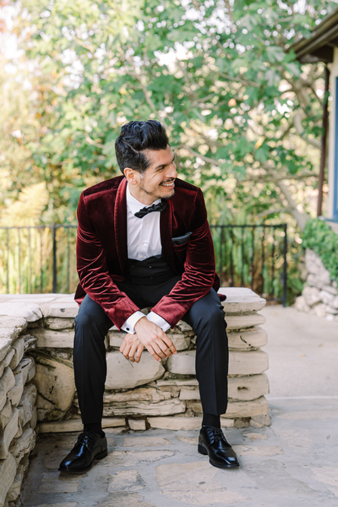  a Chinese-Spanish fusion wedding with the bride in a white flowing gown and the groom in a grey suit and burgundy velvet coat - groom in burgundy velvet coat 