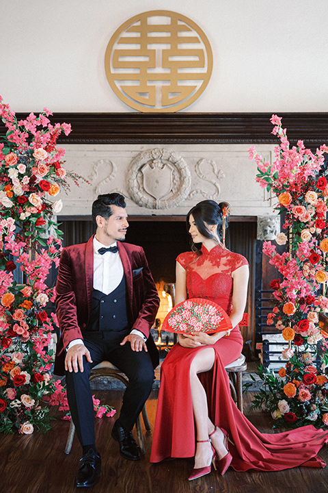  a Chinese-Spanish fusion wedding with the bride in a white flowing gown and the groom in a grey suit and burgundy velvet coat - couple at tea ceremony 