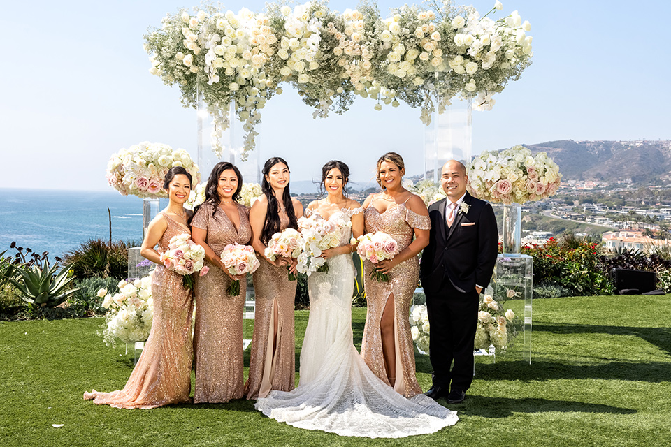  glitz and glam wedding by the beach with the bride in a lace crystal gown and the groom in a black tuxedo – bridesmaids