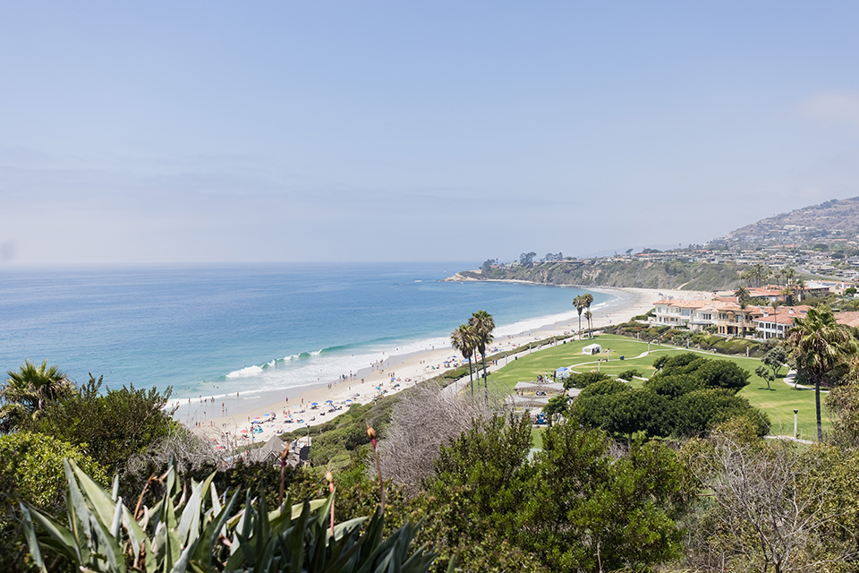  glitz and glam wedding by the beach with the bride in a lace crystal gown and the groom in a black tuxedo – ocean view