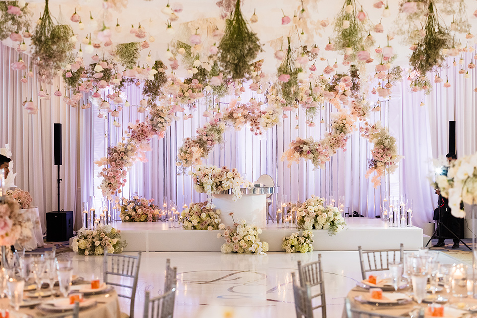  glitz and glam wedding by the beach with the bride in a lace crystal gown and the groom in a black tuxedo – reception decor