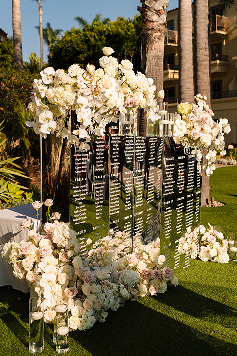  glitz and glam wedding by the beach with the bride in a lace crystal gown and the groom in a black tuxedo – seating chart