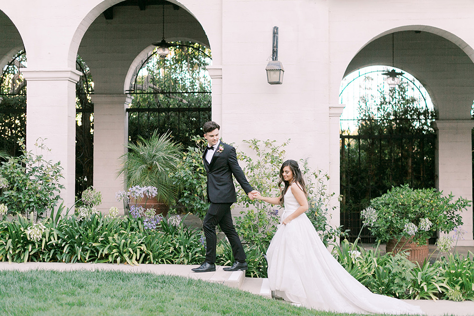  black and white classic wedding at the ebell in LA – couple walking 