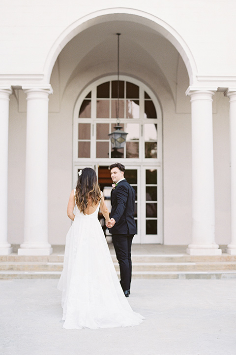  black and white classic wedding at the ebell in LA – couple on stairs 