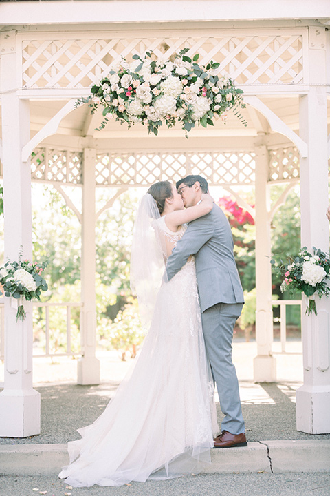  a romantic garden wedding with grey and pink décor and style, with the bride in a gorgeous white gown and the groom in a heather grey suit, the bridesmaids were in blush pink gowns and the groomsmen in heather grey suits – ceremony