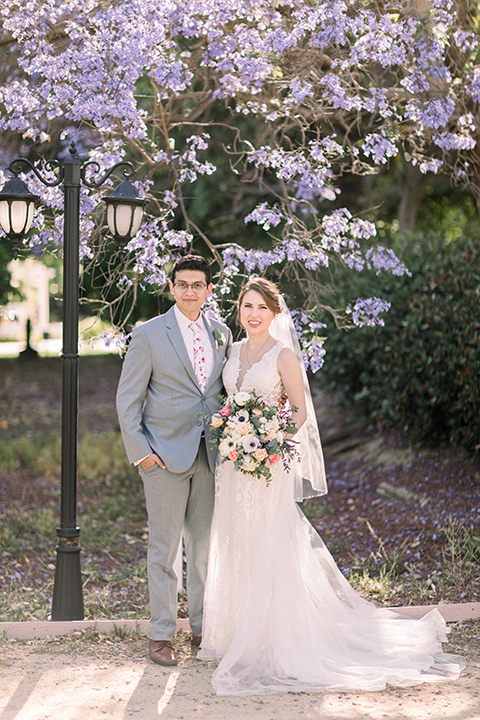  a romantic garden wedding with grey and pink décor and style, with the bride in a gorgeous white gown and the groom in a heather grey suit, the bridesmaids were in blush pink gowns and the groomsmen in heather grey suits – couple at the wedding 
