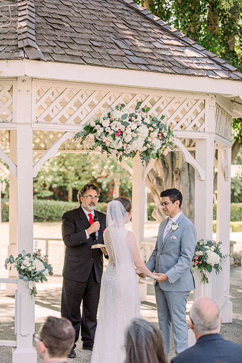  a romantic garden wedding with grey and pink décor and style, with the bride in a gorgeous white gown and the groom in a heather grey suit, the bridesmaids were in blush pink gowns and the groomsmen in heather grey suits - ceremony