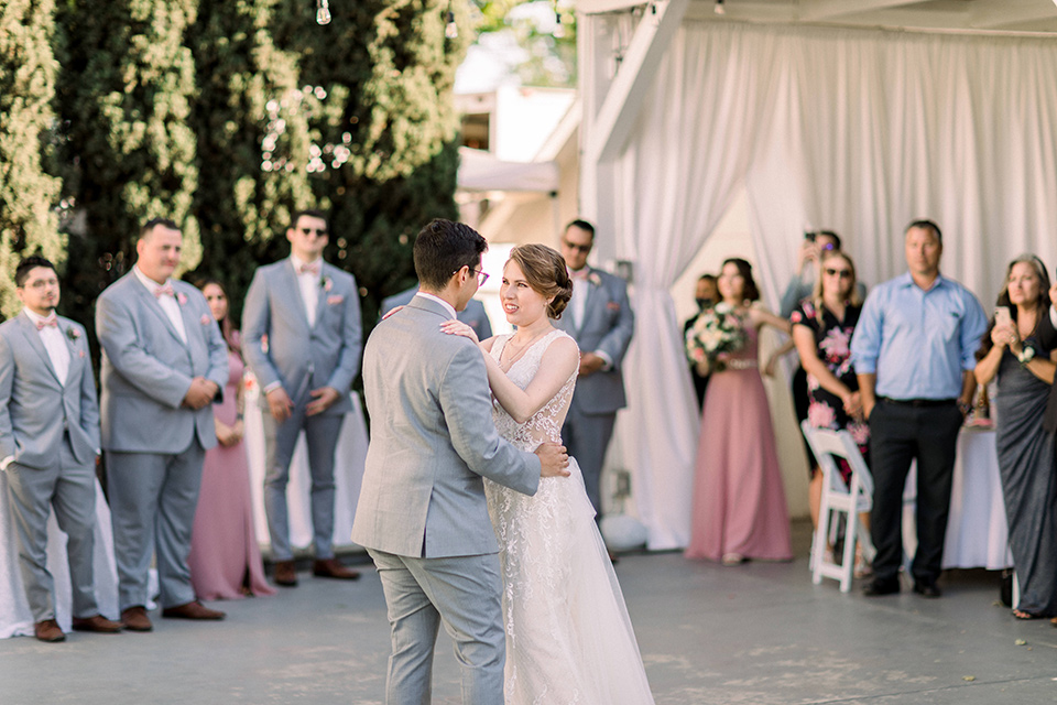  a romantic garden wedding with grey and pink décor and style, with the bride in a gorgeous white gown and the groom in a heather grey suit, the bridesmaids were in blush pink gowns and the groomsmen in heather grey suits – first dance