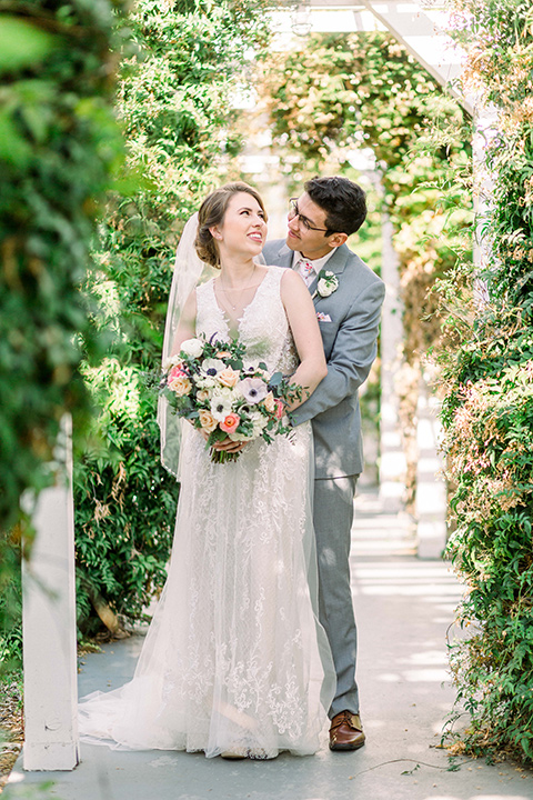  a romantic garden wedding with grey and pink décor and style, with the bride in a gorgeous white gown and the groom in a heather grey suit, the bridesmaids were in blush pink gowns and the groomsmen in heather grey suits – couple at the wedding