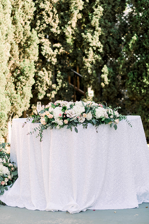  a romantic garden wedding with grey and pink décor and style, with the bride in a gorgeous white gown and the groom in a heather grey suit, the bridesmaids were in blush pink gowns and the groomsmen in heather grey suits – sweetheart table
