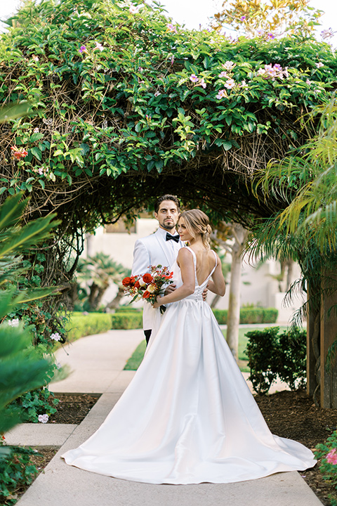  modern white and black wedding with pops of red – couple at ceremony 