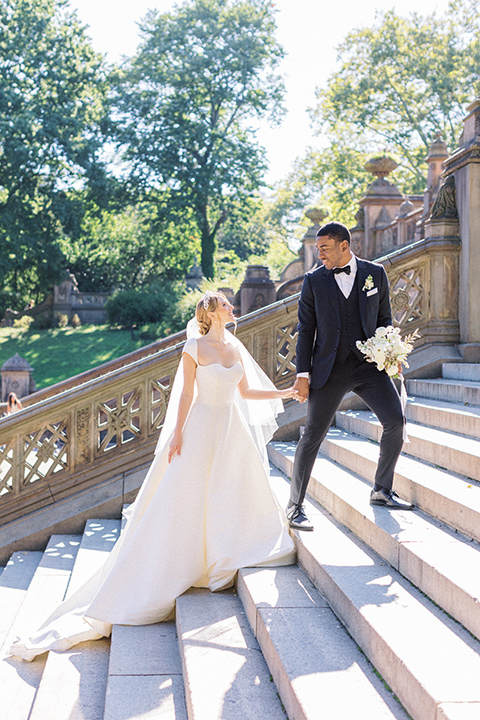  A dramatic modern black and white wedding in Central Park New York City - walking up the stairs 