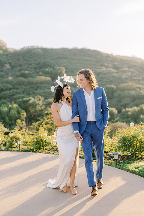  black and white beach wedding with lux details – couple walking on the mountains 