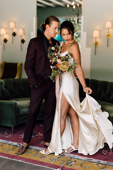  fig house shoot with burgundy and yellow details and the groom in a burgundy tuxedo – couple inside 