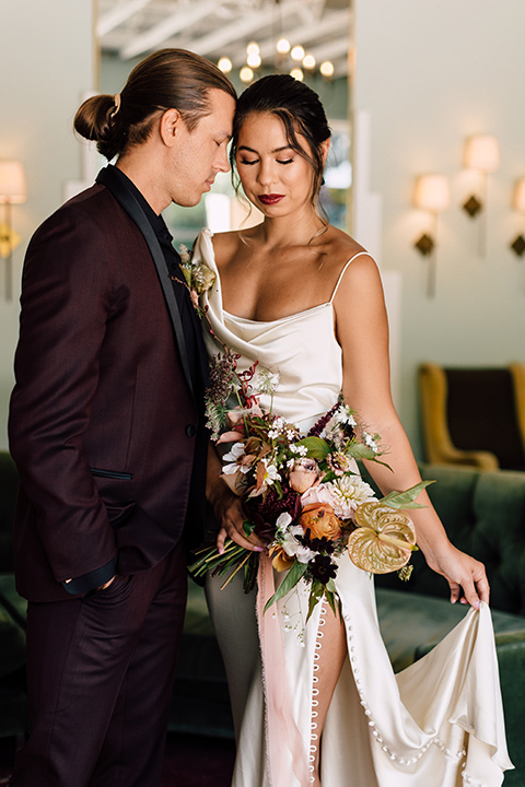  fig house shoot with burgundy and yellow details and the groom in a burgundy tuxedo – couple inside 