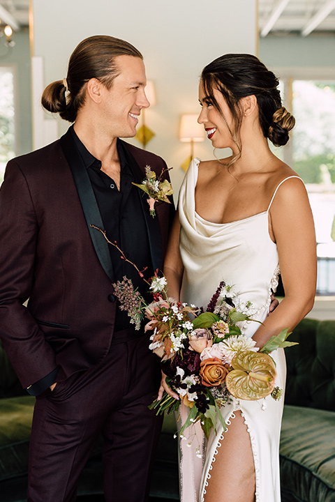  fig house shoot with burgundy and yellow details and the groom in a burgundy tuxedo – couple inside 