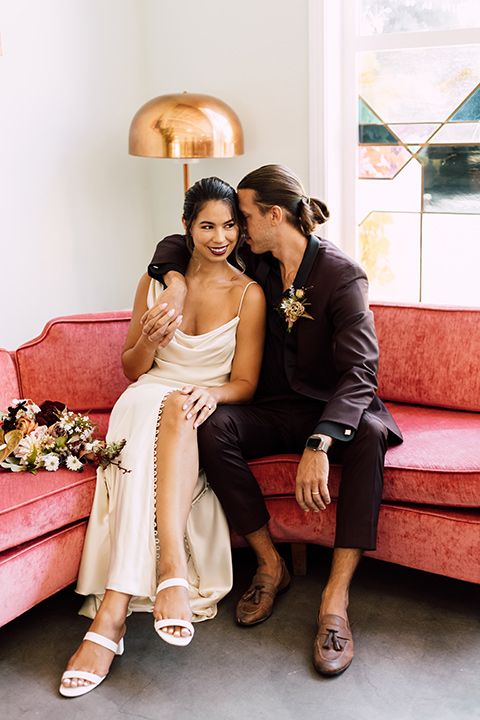  fig house shoot with burgundy and yellow details and the groom in a burgundy tuxedo – couple inside 