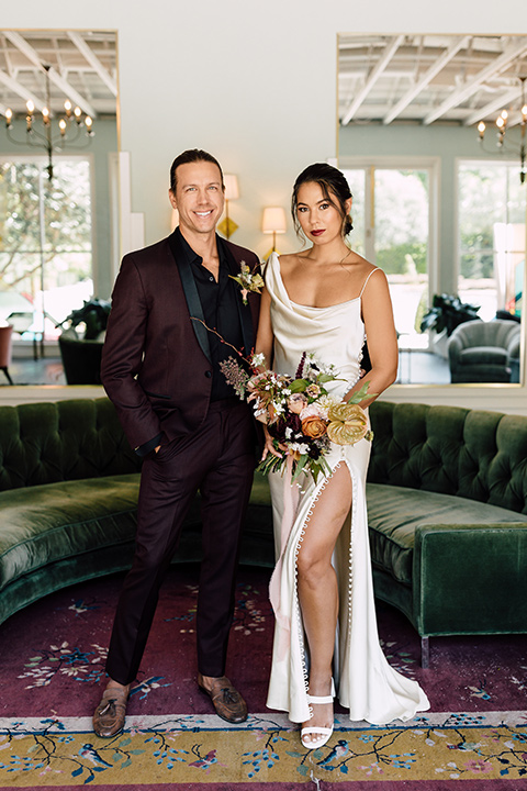  fig house shoot with burgundy and yellow details and the groom in a burgundy tuxedo – couple inside 