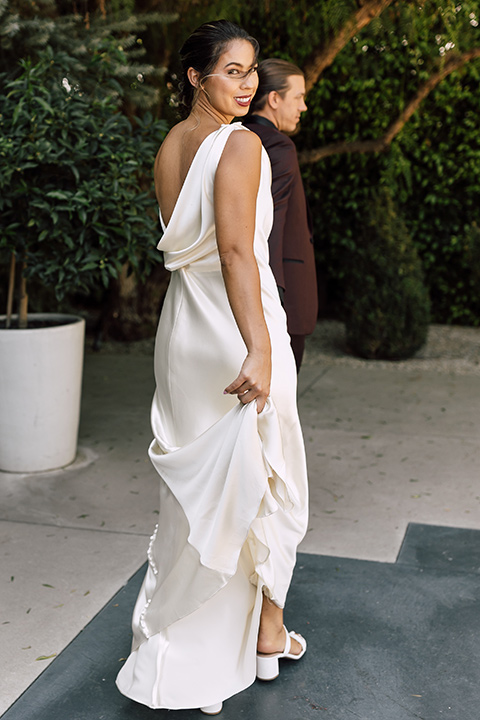  fig house shoot with burgundy and yellow details and the groom in a burgundy tuxedo – couple walking 