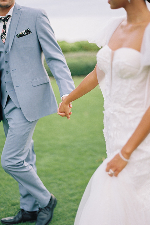  tropical tan and berry colored wedding in Hawaii – couple walking on grass 