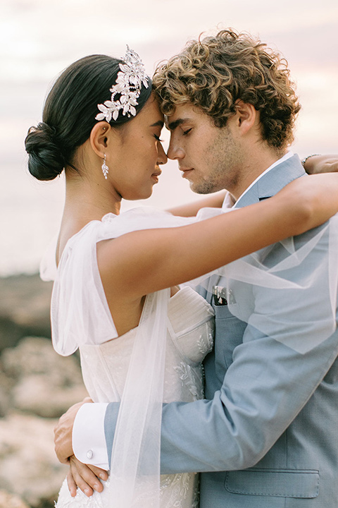  tropical tan and berry colored wedding in Hawaii – couple on arch 