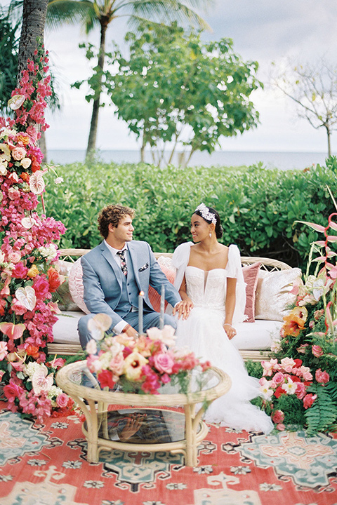  tropical tan and berry colored wedding in Hawaii – sitting at reception 