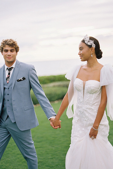  tropical tan and berry colored wedding in Hawaii – couple walking on grass 