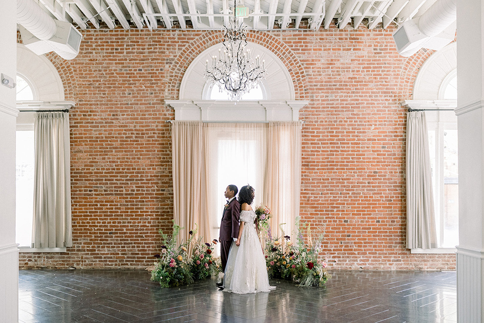  a burgundy and teal industrial winter wedding – couple in venue 