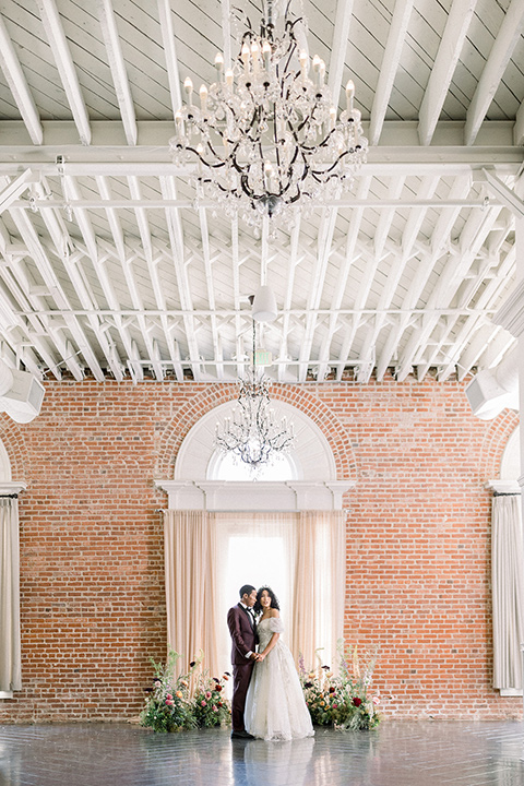  a burgundy and teal industrial winter wedding - couple close together 