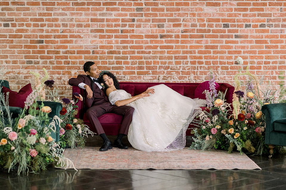  a burgundy and teal industrial winter wedding – couple on the couch 