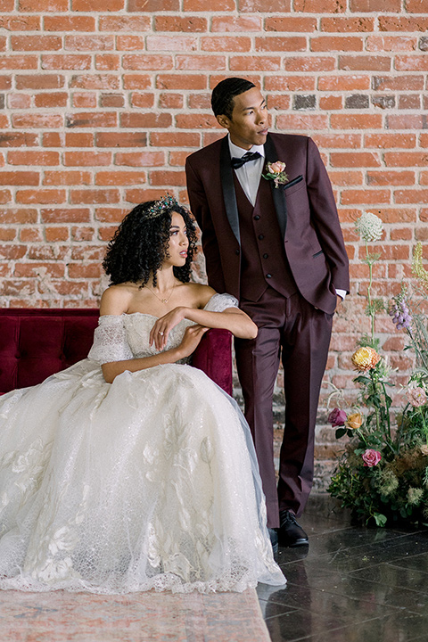  a burgundy and teal industrial winter wedding - couple close together on the couch 
