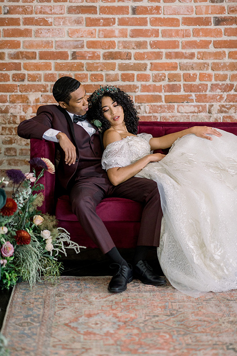  a burgundy and teal industrial winter wedding - couple close together on the couch 