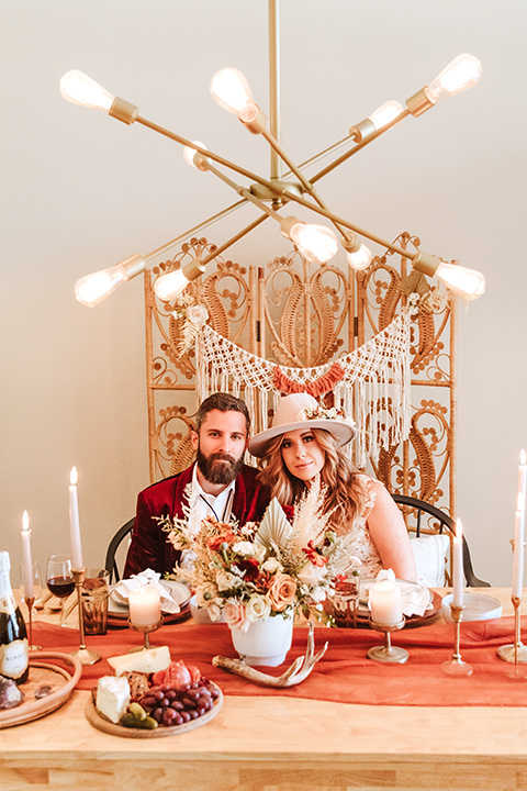  a burgundy and teal industrial winter wedding - couple at reception table 