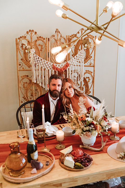  a burgundy and teal industrial winter wedding - couple at table 