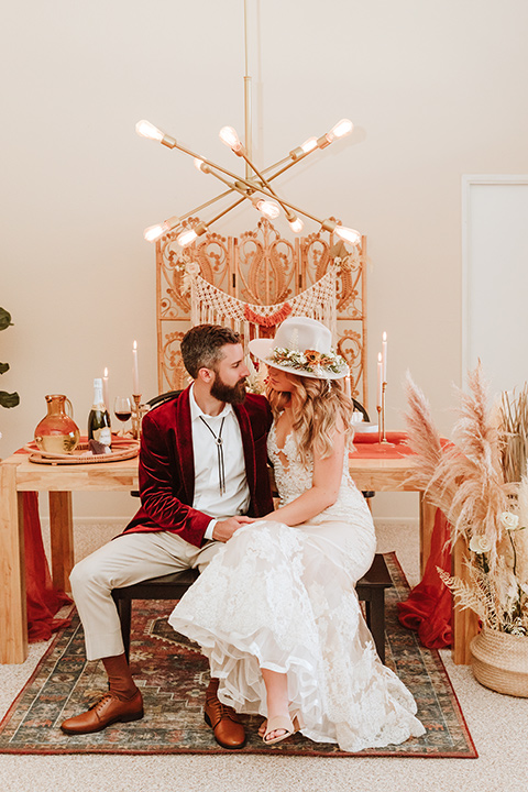  a burgundy and teal industrial winter wedding - couple at reception table 