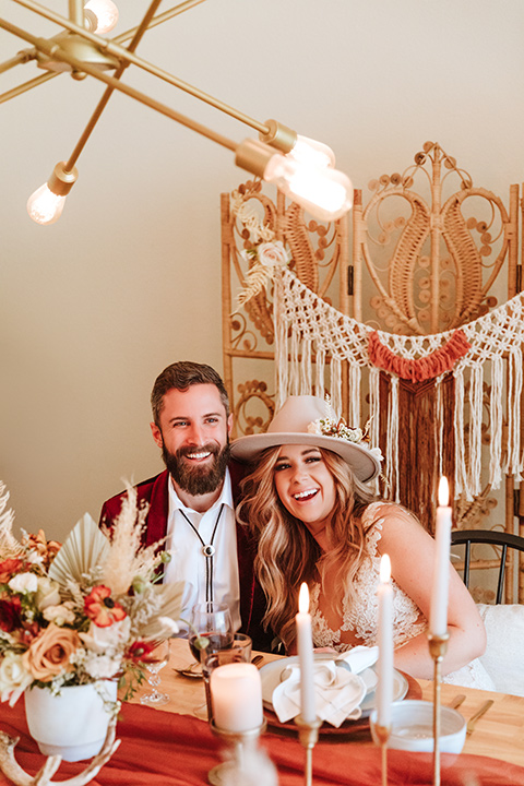  a burgundy and teal industrial winter wedding - couple at table 