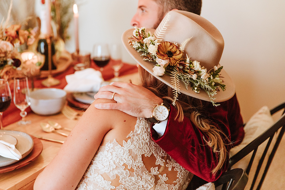  a burgundy and teal industrial winter wedding - couple at table 