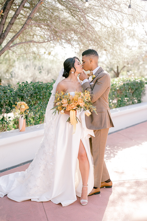  a golden toned wedding with garden details in Arizona - couple smiling 