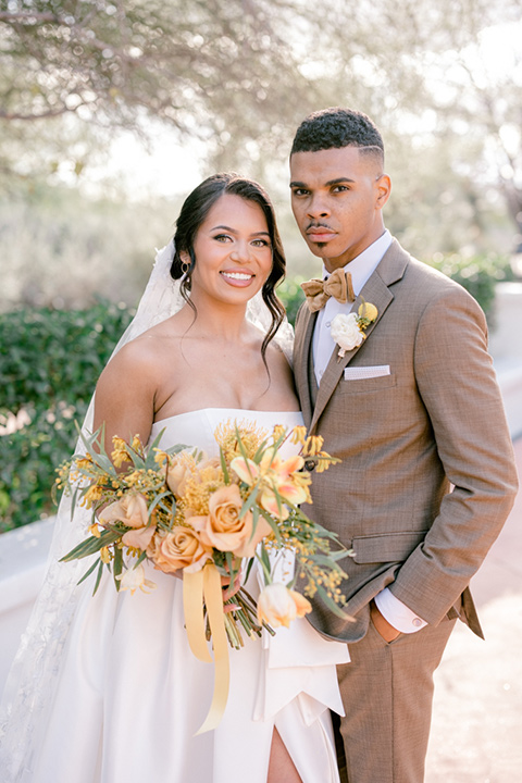  a golden toned wedding with garden details in Arizona - couple in garden 